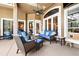 An inviting outdoor patio featuring comfortable seating, a ceiling fan, and views of the pool at 859 Windcrest Pl, Winter Springs, FL 32708