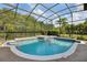 Sparkling screened-in pool and hot tub with lush landscaping and tropical ambiance at 859 Windcrest Pl, Winter Springs, FL 32708