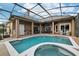 A beautiful in-ground pool and hot tub are part of the outdoor screened in living space of this home at 859 Windcrest Pl, Winter Springs, FL 32708