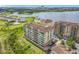 Aerial view of lakefront condos showing the community, landscaping and waterways at 8743 S The Esplanade # 18, Orlando, FL 32836