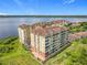 Drone shot showcasing building exteriors and waterfront views of property at 8743 S The Esplanade # 18, Orlando, FL 32836