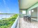Enjoy lake views from this tiled balcony featuring a table and four chairs at 8743 S The Esplanade # 18, Orlando, FL 32836