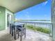 Relax on this spacious balcony with table and seating, overlooking scenic water views at 8743 S The Esplanade # 18, Orlando, FL 32836
