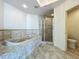Bathroom showcasing tiled bathtub and shower at 8743 S The Esplanade # 18, Orlando, FL 32836