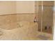 Bright bathroom featuring a soaking tub, tiled walls, and glass-enclosed shower at 8743 S The Esplanade # 18, Orlando, FL 32836