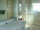 Modern bathroom with a white vanity, dual sinks, and glass shower at 8743 S The Esplanade # 18, Orlando, FL 32836
