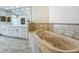 Soaking tub and double vanity in bathroom at 8743 S The Esplanade # 18, Orlando, FL 32836