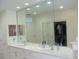 Bathroom featuring a double sink vanity with a large mirror at 8743 S The Esplanade # 18, Orlando, FL 32836