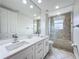Bathroom featuring a double vanity and separate tub at 8743 S The Esplanade # 18, Orlando, FL 32836