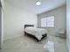 Bedroom with minimal furniture including bed and side chair at 8743 S The Esplanade # 18, Orlando, FL 32836