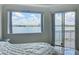 Bright bedroom featuring a stunning lake view and access to a private balcony at 8743 S The Esplanade # 18, Orlando, FL 32836