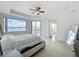 This bedroom offers amazing lake views, a ceiling fan, and access to ensuite bathroom at 8743 S The Esplanade # 18, Orlando, FL 32836