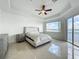 Spacious bedroom boasts a ceiling fan, beautiful lake views, and natural light at 8743 S The Esplanade # 18, Orlando, FL 32836