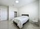 Bright bedroom with a bed, closet, and door to the left at 8743 S The Esplanade # 18, Orlando, FL 32836