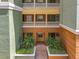Charming courtyard view with lush landscaping, classic columns, and multiple balconies at 8743 S The Esplanade # 18, Orlando, FL 32836