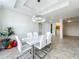 Dining area featuring modern chandelier and a view into the laundry room at 8743 S The Esplanade # 18, Orlando, FL 32836