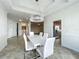 Dining area featuring modern chandelier and a view into the kitchen at 8743 S The Esplanade # 18, Orlando, FL 32836