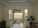 Modern dining room with a unique chandelier and ample natural light at 8743 S The Esplanade # 18, Orlando, FL 32836