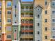 Detailed shot of a colorful condo building showcasing balconies and architectural design at 8743 S The Esplanade # 18, Orlando, FL 32836