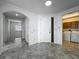 Inviting foyer with tile flooring, an arched doorway, and convenient access to the laundry area at 8743 S The Esplanade # 18, Orlando, FL 32836