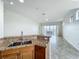 Kitchen area with granite countertops and an opening to a living area with lake views at 8743 S The Esplanade # 18, Orlando, FL 32836