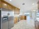 Large kitchen with stainless steel refrigerator and view to the living area at 8743 S The Esplanade # 18, Orlando, FL 32836