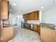 Well-lit kitchen featuring wood cabinetry, granite countertops, and stainless steel appliances at 8743 S The Esplanade # 18, Orlando, FL 32836