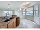 Kitchen area with granite counters, double sink, tile flooring, and bay window with view at 8743 S The Esplanade # 18, Orlando, FL 32836