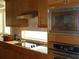 Kitchen with stainless steel appliances, granite counters, and stylish cabinets at 8743 S The Esplanade # 18, Orlando, FL 32836