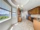 Bright eat-in kitchen featuring a chandelier, tile floors, stainless steel appliances, and a large window with a water view at 8743 S The Esplanade # 18, Orlando, FL 32836
