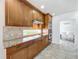 Kitchen with wood cabinets, granite countertops, tile backsplash, and stainless steel appliances at 8743 S The Esplanade # 18, Orlando, FL 32836