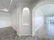 Open floor plan living area featuring unique arched niche and tile flooring at 8743 S The Esplanade # 18, Orlando, FL 32836