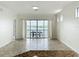 Bright living space with sliding glass doors leading to a balcony and lake views at 8743 S The Esplanade # 18, Orlando, FL 32836