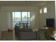 Bright living room with couch, balcony, and water view at 8743 S The Esplanade # 18, Orlando, FL 32836