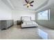 Light-filled primary bedroom featuring tray ceilings, ample space, and tile flooring at 8743 S The Esplanade # 18, Orlando, FL 32836