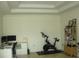 Bright office space with tray ceiling and a stationary bike at 8743 S The Esplanade # 18, Orlando, FL 32836