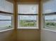 Bay windows overlooking green spaces with views of the lake and distant city buildings at 8743 S The Esplanade # 18, Orlando, FL 32836