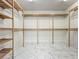 Spacious walk-in closet with custom wooden shelving, perfect for organizing clothes at 8743 S The Esplanade # 18, Orlando, FL 32836