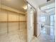 Spacious walk-in closet with custom shelving and mirror door, offering ample storage at 8743 S The Esplanade # 18, Orlando, FL 32836