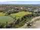 This aerial shows a winding path leading to a waterfront gazebo, amidst lush greenery and neighborhood tranquility at 920 Nola Dr, Ocoee, FL 34761