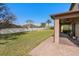 A backyard featuring a brick paver patio, lush lawn, and white vinyl fence, perfect for outdoor enjoyment at 920 Nola Dr, Ocoee, FL 34761