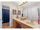 Bathroom with double sink vanity, decorative seashell accents, and tiled floors at 920 Nola Dr, Ocoee, FL 34761