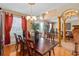 Elegant dining room with hardwood floors and views to the foyer and living room at 920 Nola Dr, Ocoee, FL 34761