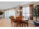 Cozy dining room featuring a wooden table, chairs, and natural light from large windows at 920 Nola Dr, Ocoee, FL 34761