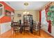 Elegant dining room with hardwood floors, chandelier, and ample seating at 920 Nola Dr, Ocoee, FL 34761