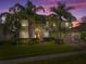 Stunning two-story home with lush landscaping and a three-car garage at sunset at 920 Nola Dr, Ocoee, FL 34761