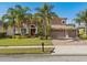 Charming two-story home with lush landscaping, brick paved driveway, and a three-car garage at 920 Nola Dr, Ocoee, FL 34761