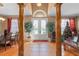 Grand foyer with tile flooring, decorative columns and a view of the front door at 920 Nola Dr, Ocoee, FL 34761