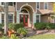 Elegant arched entryway with double doors and manicured landscaping at 920 Nola Dr, Ocoee, FL 34761