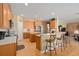 Well-lit kitchen with wooden cabinetry, stainless steel appliances, and a breakfast bar at 920 Nola Dr, Ocoee, FL 34761